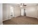 Large bedroom with neutral carpet and views to the bathroom and closet at 823 E Agua Fria Ln, Avondale, AZ 85323