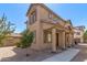 Charming tan home featuring desert landscaping, covered entry, and sidewalk at 823 E Agua Fria Ln, Avondale, AZ 85323