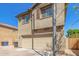 Two-story tan home featuring a two car garage and desert landscaping in front at 823 E Agua Fria Ln, Avondale, AZ 85323