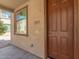 Charming tan home featuring address and a window next to the front door at 823 E Agua Fria Ln, Avondale, AZ 85323