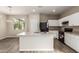 Modern kitchen with sleek black appliances, white cabinetry, and a central island perfect for cooking at 823 E Agua Fria Ln, Avondale, AZ 85323