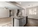 Open concept, eat-in kitchen with stainless steel sink and view to the living and dining rooms at 823 E Agua Fria Ln, Avondale, AZ 85323