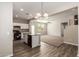 Modern kitchen featuring stainless appliances, white cabinets, and an island sink with views to the living room at 823 E Agua Fria Ln, Avondale, AZ 85323