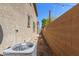 Side yard features gravel, a block wall and the home's AC compressor at 823 E Agua Fria Ln, Avondale, AZ 85323