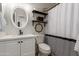 Bright bathroom featuring dark wood shelves, a black and white shower curtain, and a round mirror at 872 E Saratoga St, Gilbert, AZ 85296
