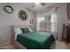 Bright bedroom featuring carpet, an inviting bed, decorative wall art, and a sunny window at 872 E Saratoga St, Gilbert, AZ 85296