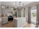 Charming kitchen with a center island, stainless steel appliances, and sliding doors for easy outdoor access at 872 E Saratoga St, Gilbert, AZ 85296