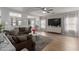 Inviting living room showcases a plush sectional, large TV, and stylish decor, creating a cozy atmosphere at 872 E Saratoga St, Gilbert, AZ 85296