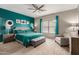 This main bedroom features carpet, a ceiling fan, an accent wall, bench and sitting area near a window at 872 E Saratoga St, Gilbert, AZ 85296