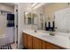 This traditional bathroom boasts double sinks, a large mirror, and neutral walls at 927 S Ash St, Gilbert, AZ 85233