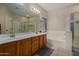 Bright bathroom features double sinks, soaking tub and glass-enclosed shower at 927 S Ash St, Gilbert, AZ 85233