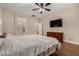 Comfortable bedroom featuring a large bed, ceiling fan, and an ensuite bathroom at 927 S Ash St, Gilbert, AZ 85233