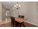 Elegant dining room features a wooden table with seating for four and modern chandelier at 927 S Ash St, Gilbert, AZ 85233