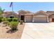 Charming single-story home boasts a two-car garage, desert landscaping, and an American flag at 927 S Ash St, Gilbert, AZ 85233