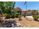 Inviting home exterior with desert landscaping, stone accents, and a well-maintained lawn at 927 S Ash St, Gilbert, AZ 85233