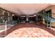 Sunlit interior with a tiled floor, bench, and various shops at 927 S Ash St, Gilbert, AZ 85233