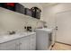 This laundry room offers a sink, plenty of storage, and modern washer and dryer at 927 S Ash St, Gilbert, AZ 85233