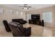 Cozy living room featuring tile floors, comfortable seating, and a large-screen television at 927 S Ash St, Gilbert, AZ 85233