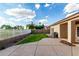 Spacious backyard with a well-maintained lawn and a patio area for outdoor entertaining at 1022 S Butte Ln, Gilbert, AZ 85296