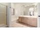 Bathroom with double sink vanity, large mirror, shower, and separate soaking tub at 1022 S Butte Ln, Gilbert, AZ 85296