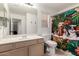 Bathroom with single sink vanity and bathtub with a dog-themed shower curtain at 1022 S Butte Ln, Gilbert, AZ 85296