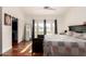 Comfortable bedroom featuring hardwood floors, french doors, a ceiling fan, and natural light at 1022 S Butte Ln, Gilbert, AZ 85296