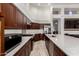 Spacious kitchen with stainless steel appliances, a large island, granite countertops, and cherry wood cabinets at 1022 S Butte Ln, Gilbert, AZ 85296