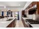 Beautiful kitchen with island, granite counters, stainless steel appliances, and dark wood cabinets at 1022 S Butte Ln, Gilbert, AZ 85296