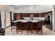 Bright kitchen featuring granite countertops, stainless steel appliances, a large island, and dark wood cabinetry at 1022 S Butte Ln, Gilbert, AZ 85296