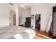 Bright main bedroom featuring wood floors, ceiling fan, dresser, and large closet at 1022 S Butte Ln, Gilbert, AZ 85296