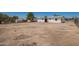 Large, fenced backyard featuring outbuildings and a home with white paint at 10693 N Arapaho Dr, Casa Grande, AZ 85122