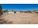 Sunny backyard featuring a white home with fenced boundaries at 10693 N Arapaho Dr, Casa Grande, AZ 85122