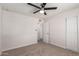 Bedroom featuring ceiling fan, carpeted floors, and sliding closet doors at 10693 N Arapaho Dr, Casa Grande, AZ 85122