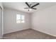 Neutral bedroom featuring a ceiling fan, a window, and carpeted floors at 10693 N Arapaho Dr, Casa Grande, AZ 85122