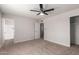 Neutral bedroom with a ceiling fan and attached bathroom at 10693 N Arapaho Dr, Casa Grande, AZ 85122