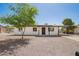Charming single-story home featuring a gravel yard, covered entry, and convenient covered parking at 10693 N Arapaho Dr, Casa Grande, AZ 85122