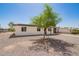 Single-story home showcasing a gravel yard, simple covered entry, and convenient covered parking at 10693 N Arapaho Dr, Casa Grande, AZ 85122