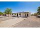 Single-story home showcasing a driveway, simple covered entry, and convenient covered parking at 10693 N Arapaho Dr, Casa Grande, AZ 85122