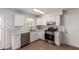 Bright kitchen with white cabinets, stainless steel appliances, and a window with natural light at 10693 N Arapaho Dr, Casa Grande, AZ 85122