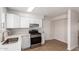 Bright kitchen featuring stainless steel appliances, white cabinets, and tiled floors at 10693 N Arapaho Dr, Casa Grande, AZ 85122
