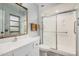 This bathroom features a large vanity, framed mirror, and a glass enclosed shower at 10913 W Caron Dr, Sun City, AZ 85351