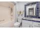 This bathroom has custom tile, a large vanity and tub-shower combo at 10913 W Caron Dr, Sun City, AZ 85351