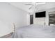 This bedroom offers a comfortable space with a ceiling fan and a TV on a dresser at 10913 W Caron Dr, Sun City, AZ 85351