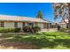 Spacious backyard, manicured landscaping, and partial view of the building's exterior offer great outdoor living at 10913 W Caron Dr, Sun City, AZ 85351