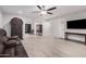 Open-concept living room with hardwood floors, ample lighting, comfortable furniture, and an easy access to the kitchen at 10913 W Caron Dr, Sun City, AZ 85351