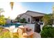 Sunlit backyard features a sparkling pool, patio seating, and outdoor grill for entertaining at 11829 W Patrick Ln, Sun City, AZ 85373