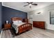 A spacious bedroom features wood furniture, great light, and stylish design at 11829 W Patrick Ln, Sun City, AZ 85373