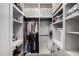 Walk-in closet offering ample storage space with built-in shelves and hanging racks at 11829 W Patrick Ln, Sun City, AZ 85373