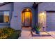 Close up of home entry featuring an arched entryway and desert landscaping at 11829 W Patrick Ln, Sun City, AZ 85373