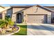 Inviting home with well-manicured artificial lawn, desert landscaping, and a spacious driveway at 11829 W Patrick Ln, Sun City, AZ 85373